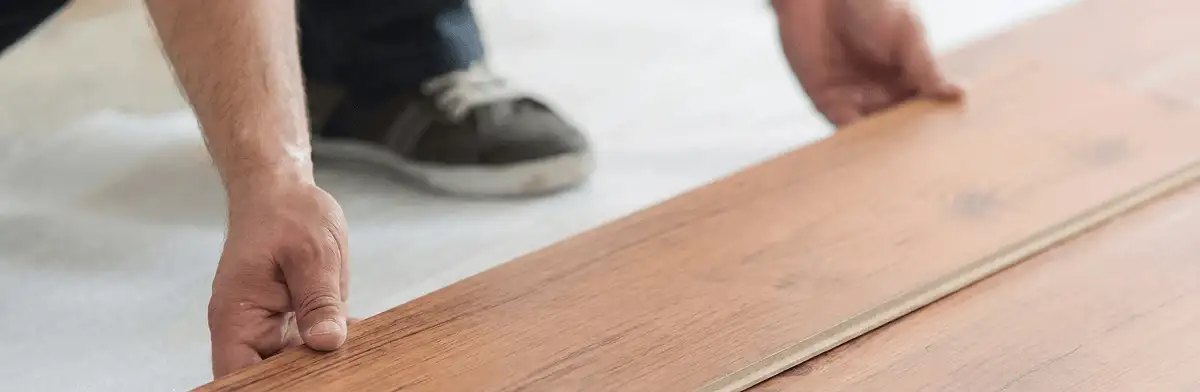 A professional installing laminate flooring in Sioux Falls, SD
